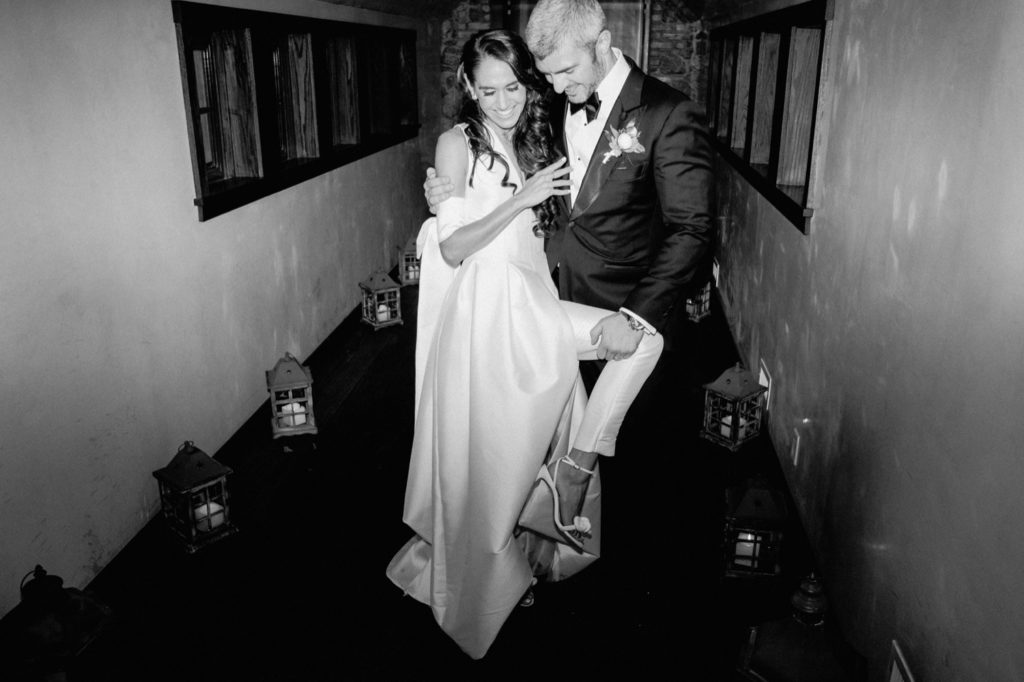 Black and white flash shot of chic couple at wedding