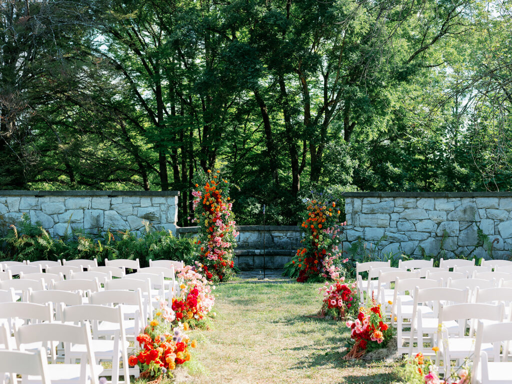 Outdoor garden wedding ceremony in Napa Valley with colorful florals. 