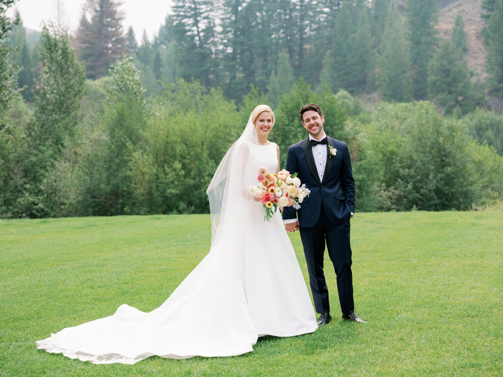 Bride and groom traditional portrait with a backdrop of pine trees in Sun Valley, Idaho.