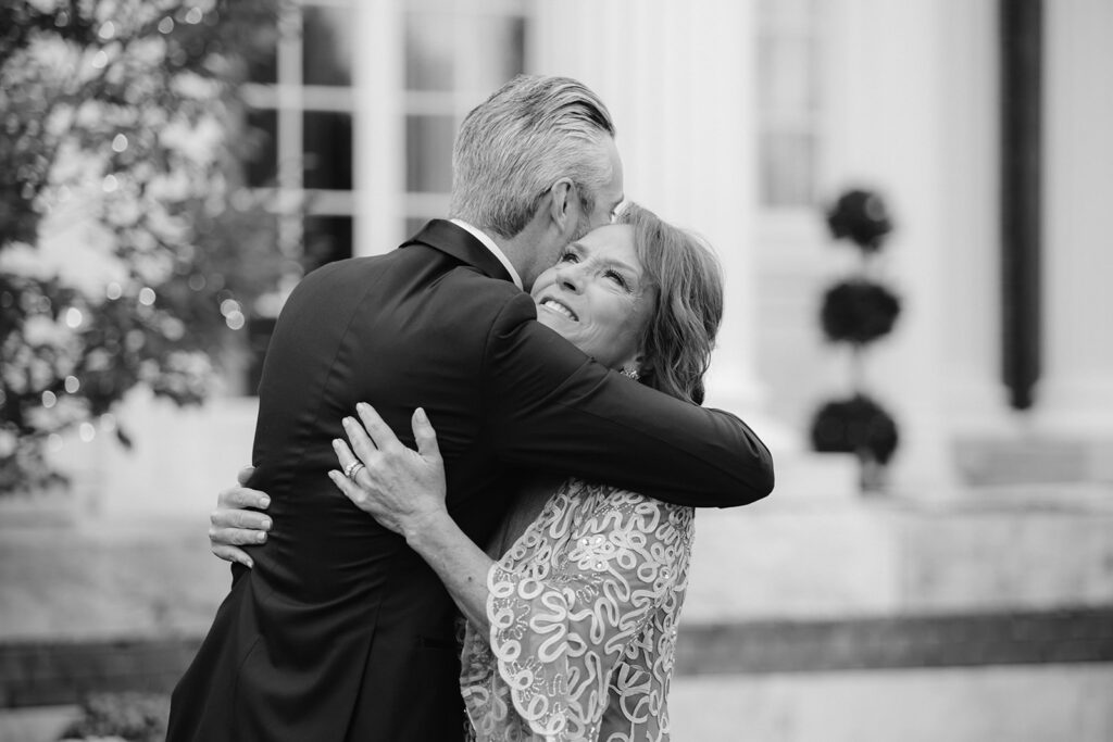 Groom hugging his mom after first look.