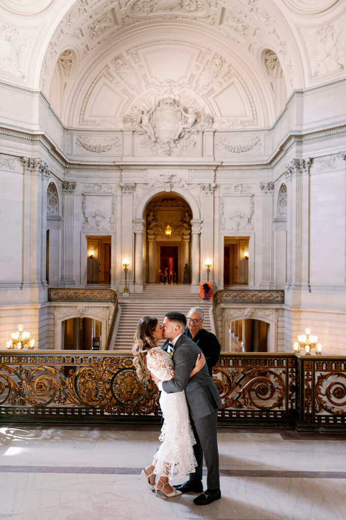 Bride and groom first kiss during their intimate wedding ceremony at San Francisco City Hall. 