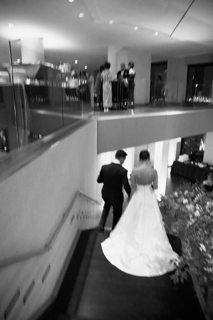 Boston State Room wedding bride and groom walking down the stairs to their reception.