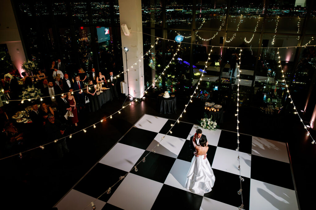 Boston State Room wedding reception bride and groom first dance on a checkered dance floor. 