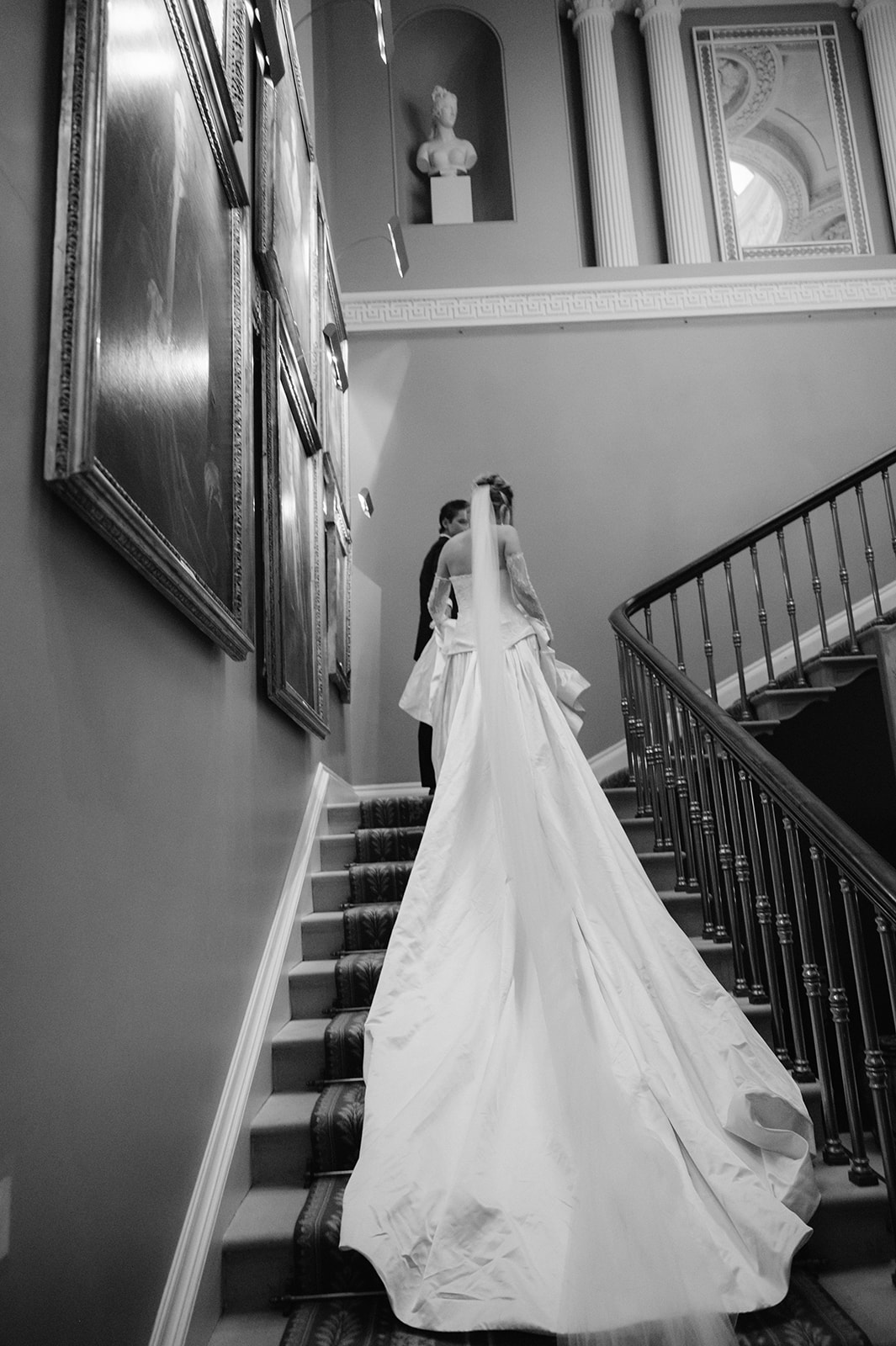Bride and groom walking up the staircase at Ballyfin Demesne.