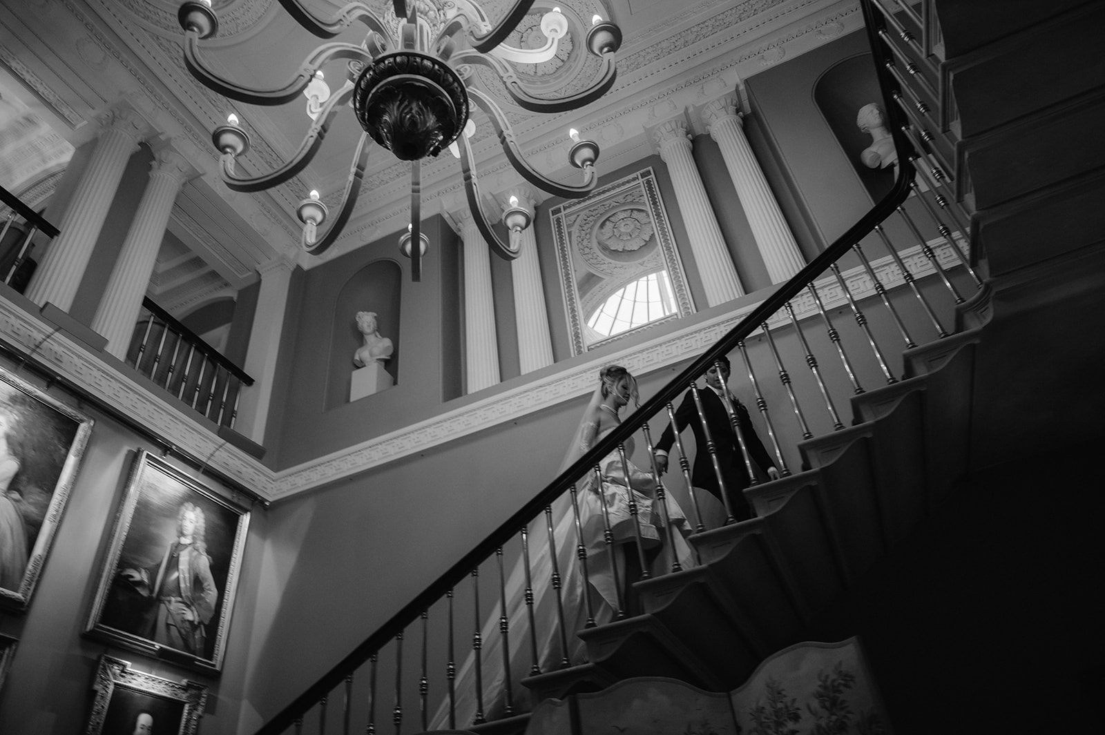 Bride and groom walking up the stairs of their venue Ballyfin Demesne in Ireland.