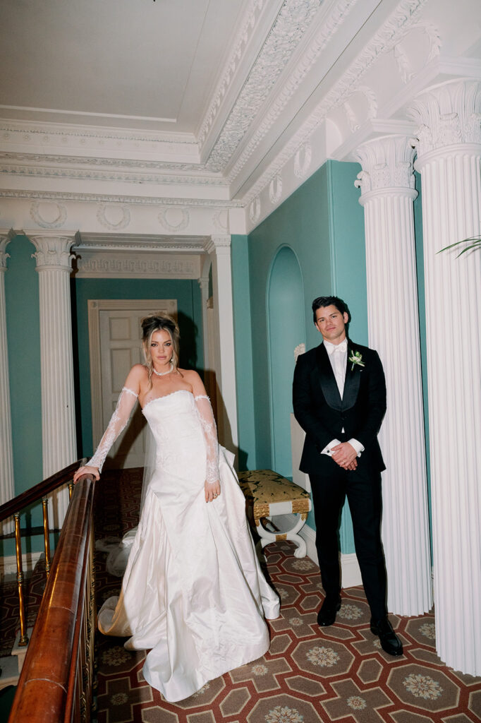 Bride and groom posing in the hallway of their wedding venue Ballyfin Demesne hotel.