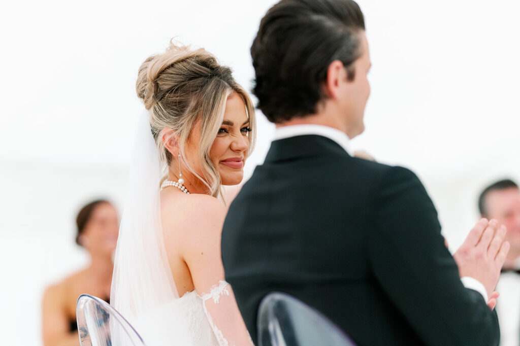 Bride scrunching her nose and loving looking at her groom during their wedding ceremony.