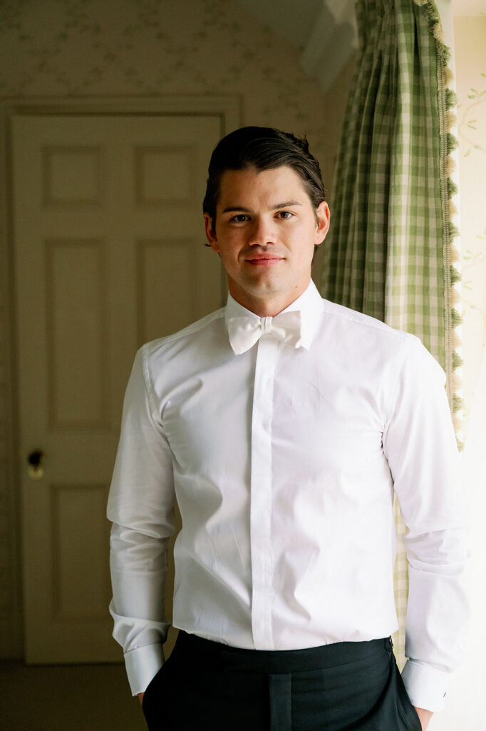 Groom wearing a white shirt and bowtie.