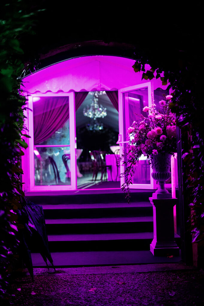 Sexy bistro-style wedding reception party with neon purple lights.