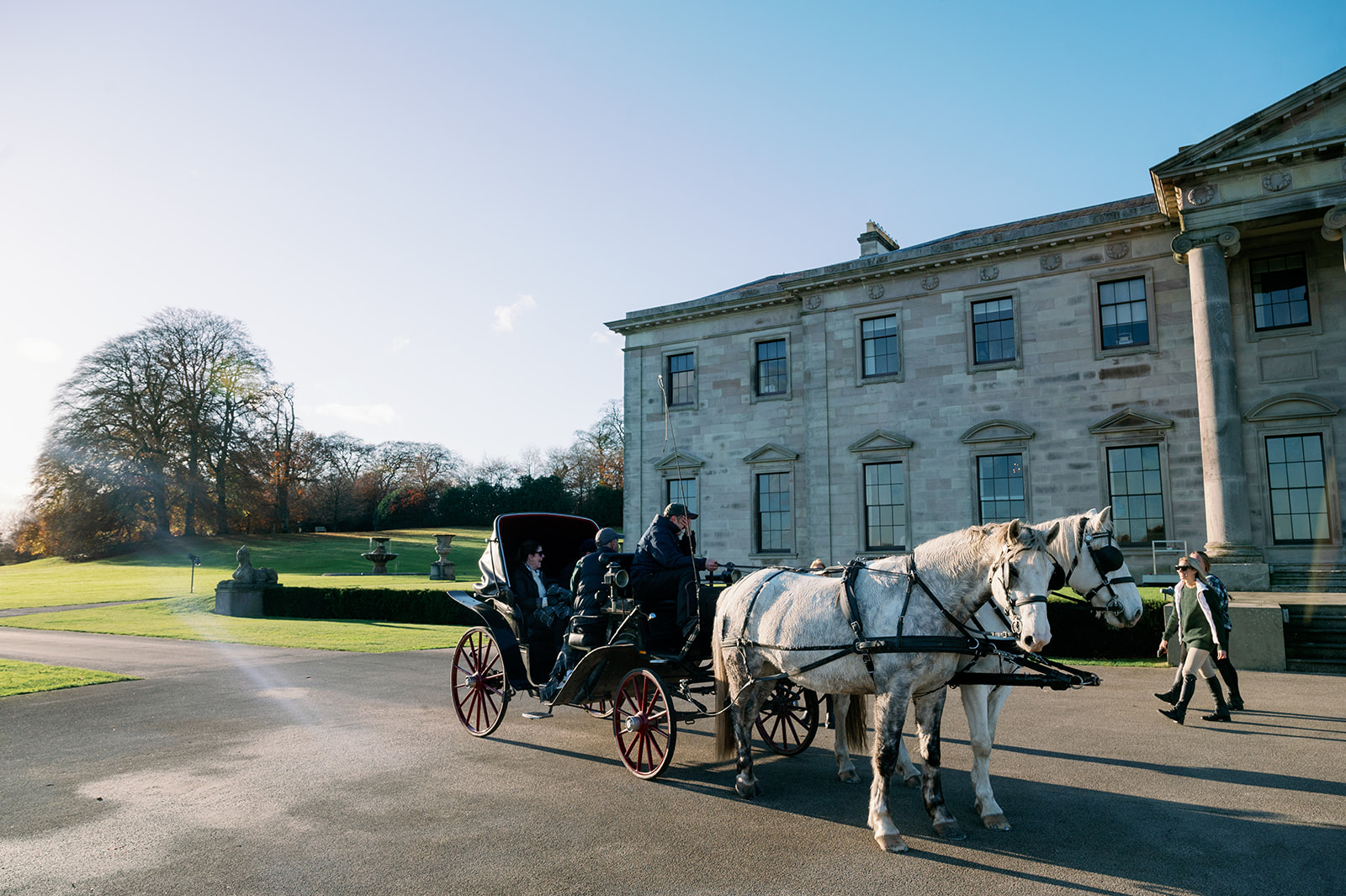 Carriage with two horses outside the entrance of Ballyfin Demesne.