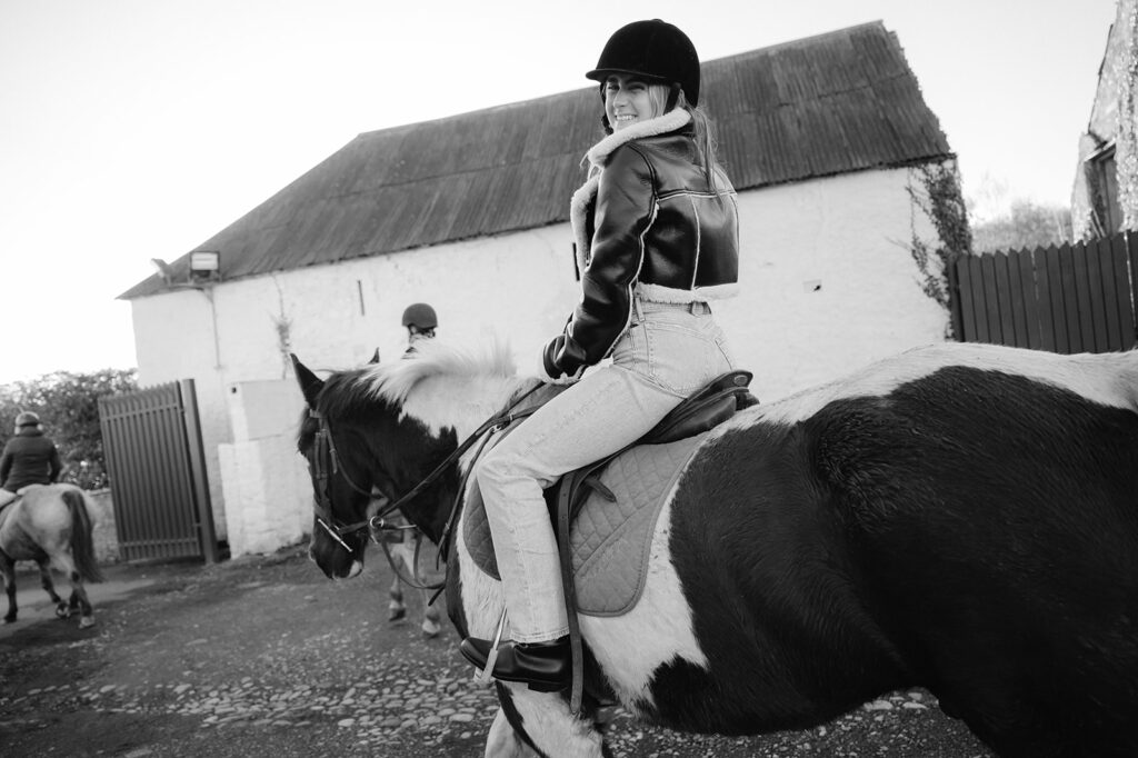 A woman riding a horse at the Ballyfin Demesne stables.
