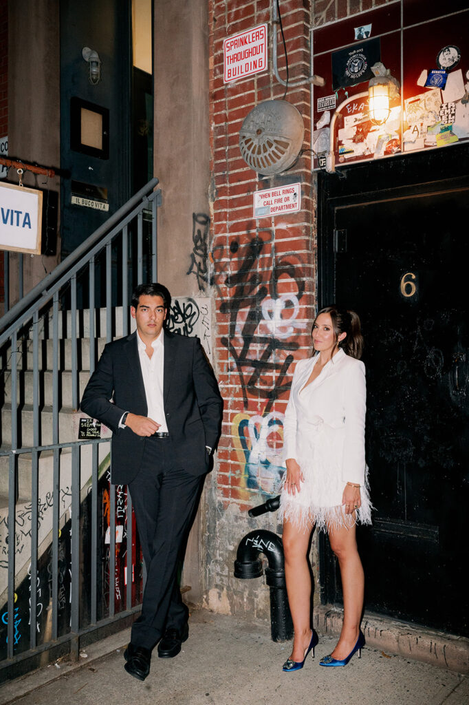 Couple posing in front of a graffiti wall in East Village New York for their urban engagement photoshoot. 