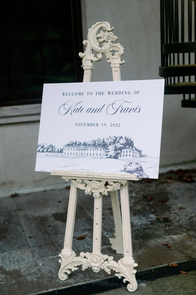 Modern wedding welcome sign on a white victorian easel.