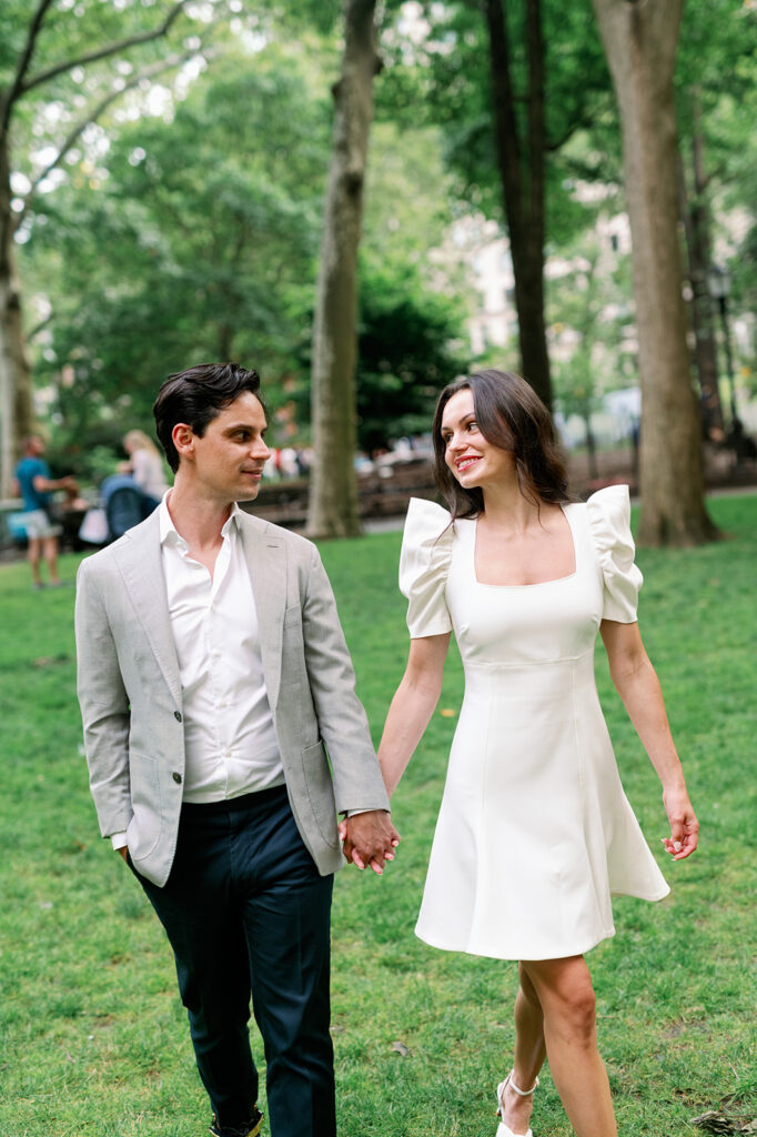 Elegant couple walking through Madison Square Park for their New York engagement photos. 