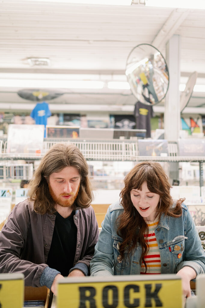Couple looking through rock albums in a New York City record shop.