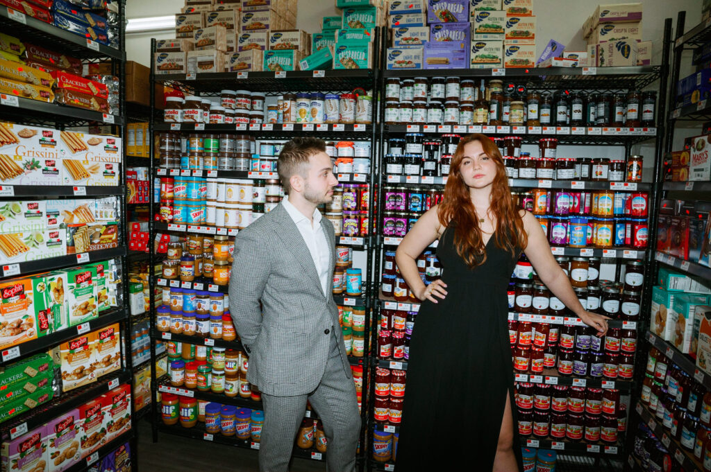 Chic couple posing in a New York City bodega. 