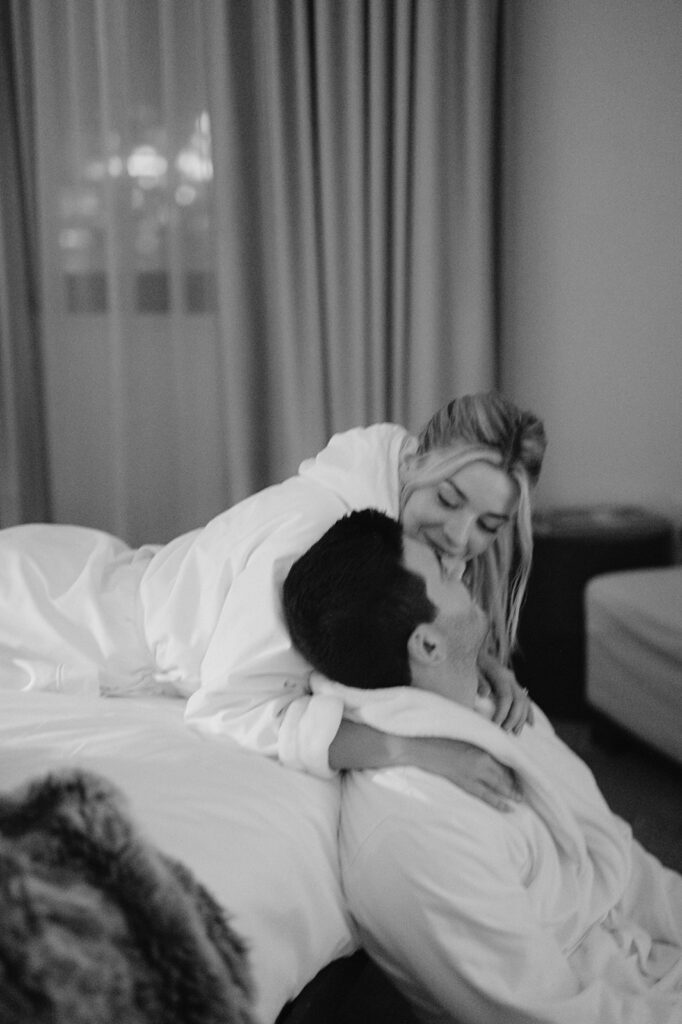 Couple sharing an intimate moment in a New York City hotel suite. 
