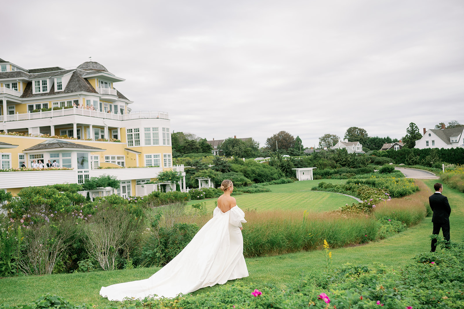 A romantic bride and groom first look in the garden of Ocean House Resort in Rhode Island.