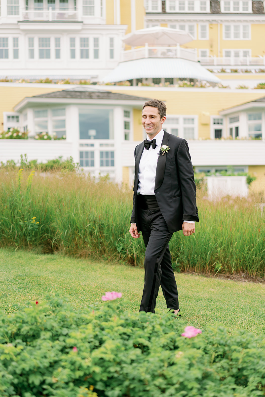 A groom seeing his bride for the first time on their wedding day outside Ocean House in Rhode Island.