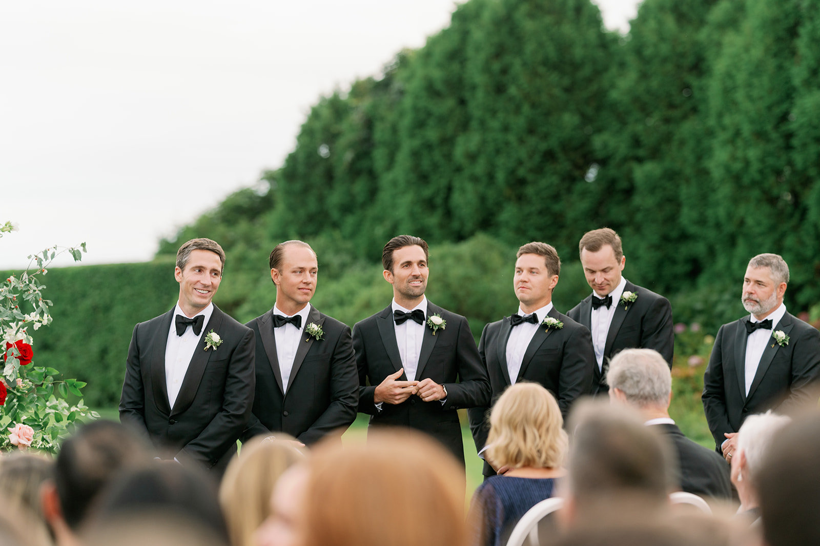 Groom and groomsmen standing at the altar of a romantic garden wedding in Rhode Island. 