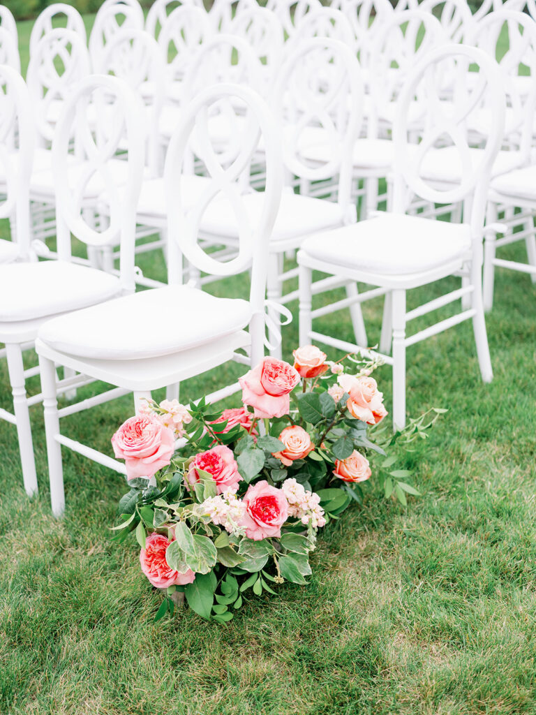 Romantic pink wedding aisle floral arrangement.
