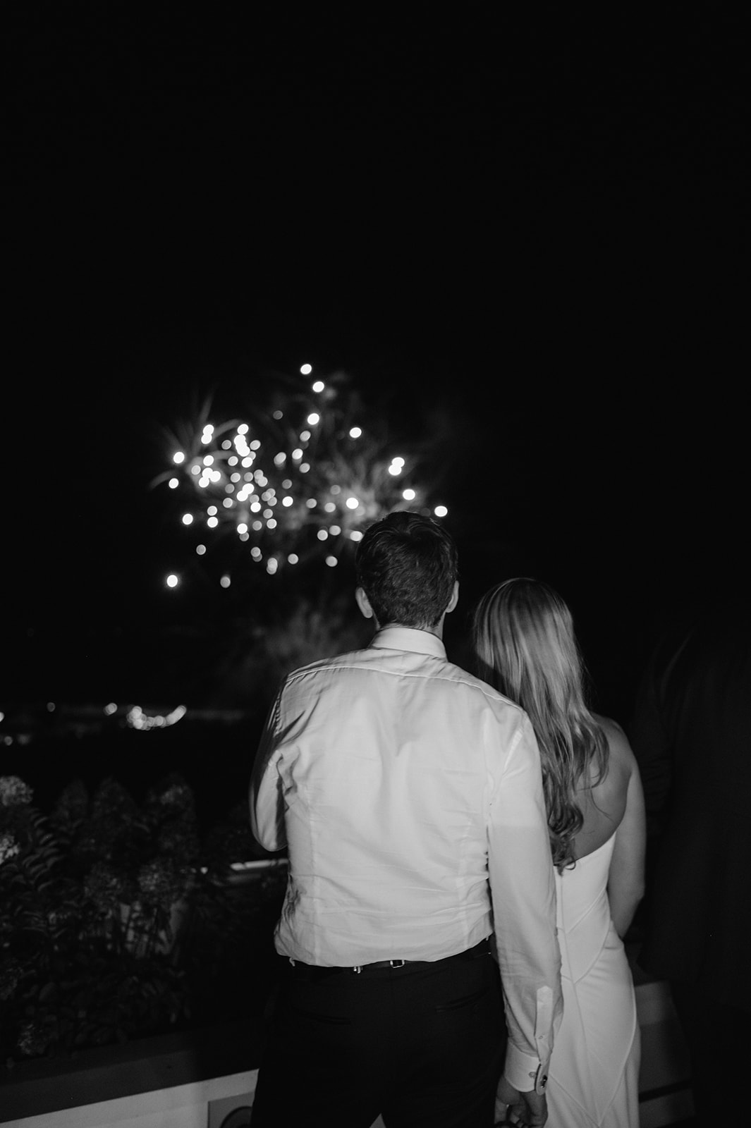Bride and groom watching fireworks during their wedding reception in Rhode Island. 