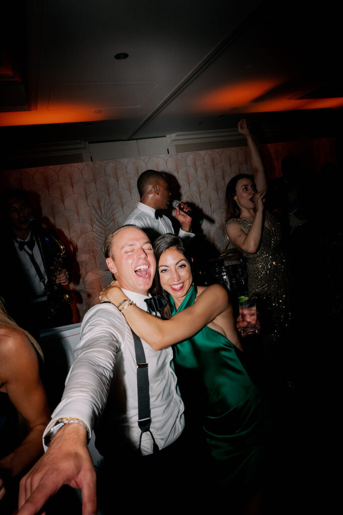 Wedding guests dancing during a reception dance party. 
