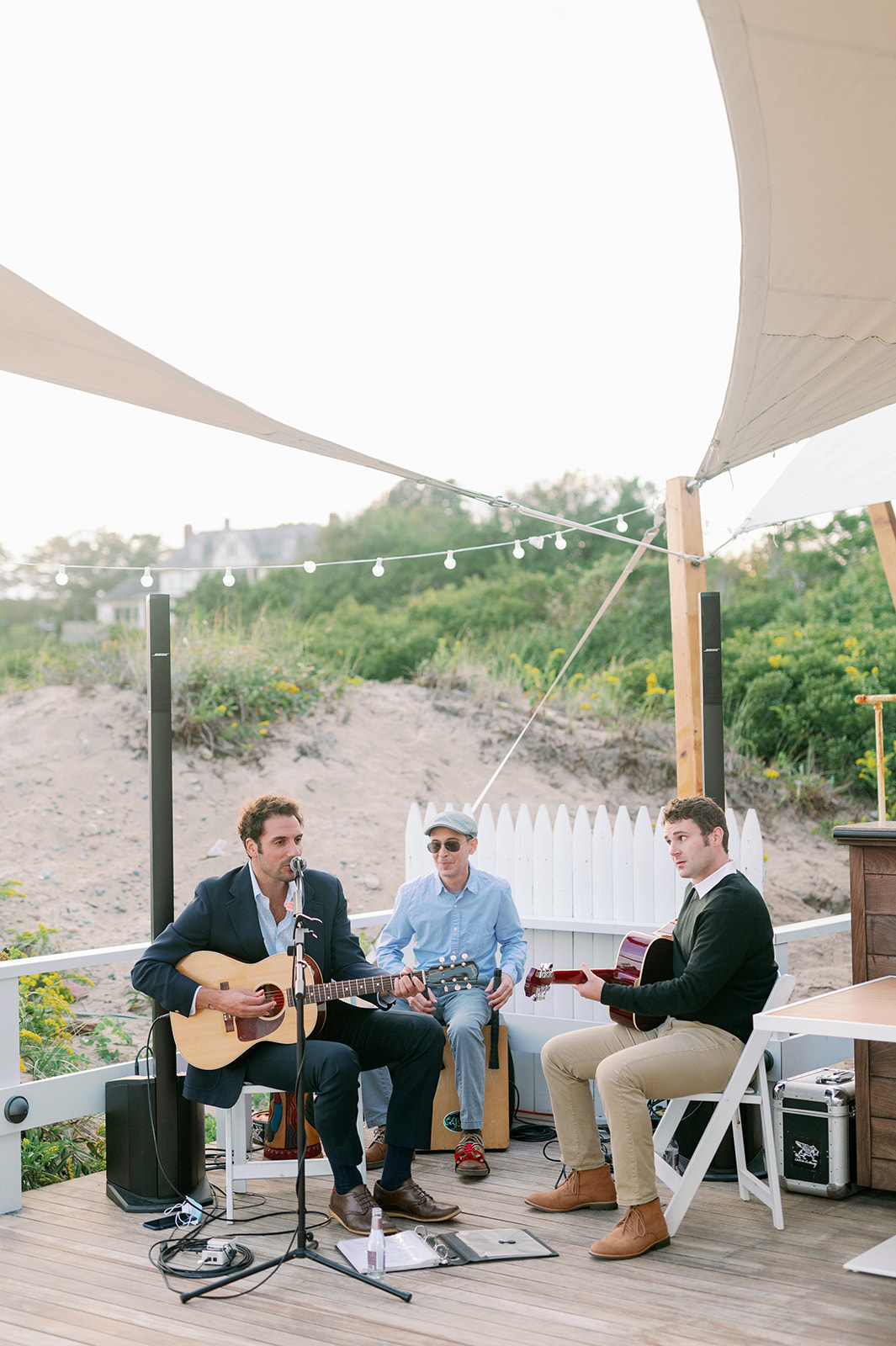 A live band playing at a beachfront rehearsal dinner in Rhode Island.