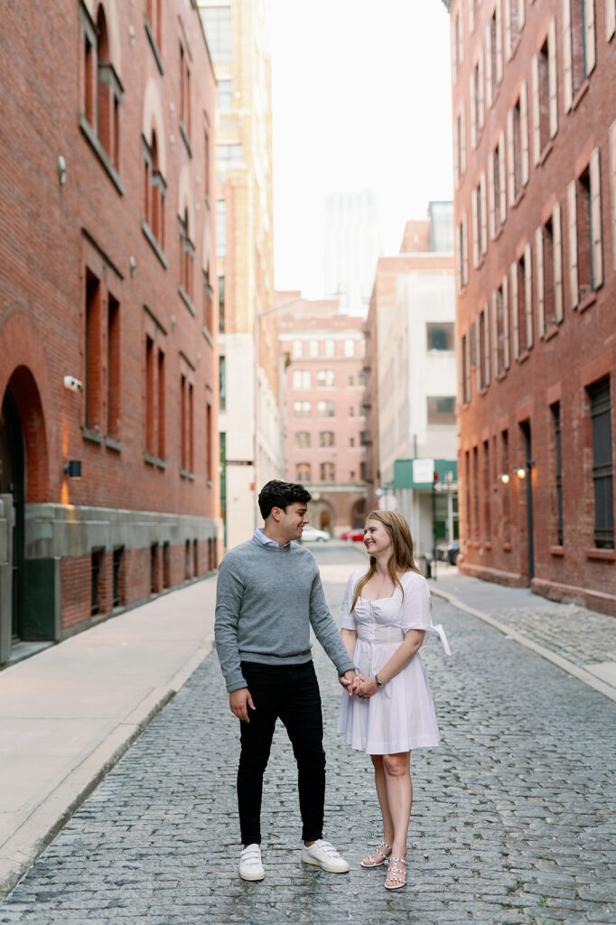 Couple walking through a charming urban street in Tribeca, New York. 