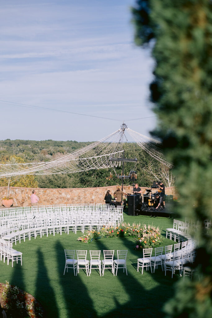 Romantic outdoor vineyard wedding ceremony with a circle seating arrangement.