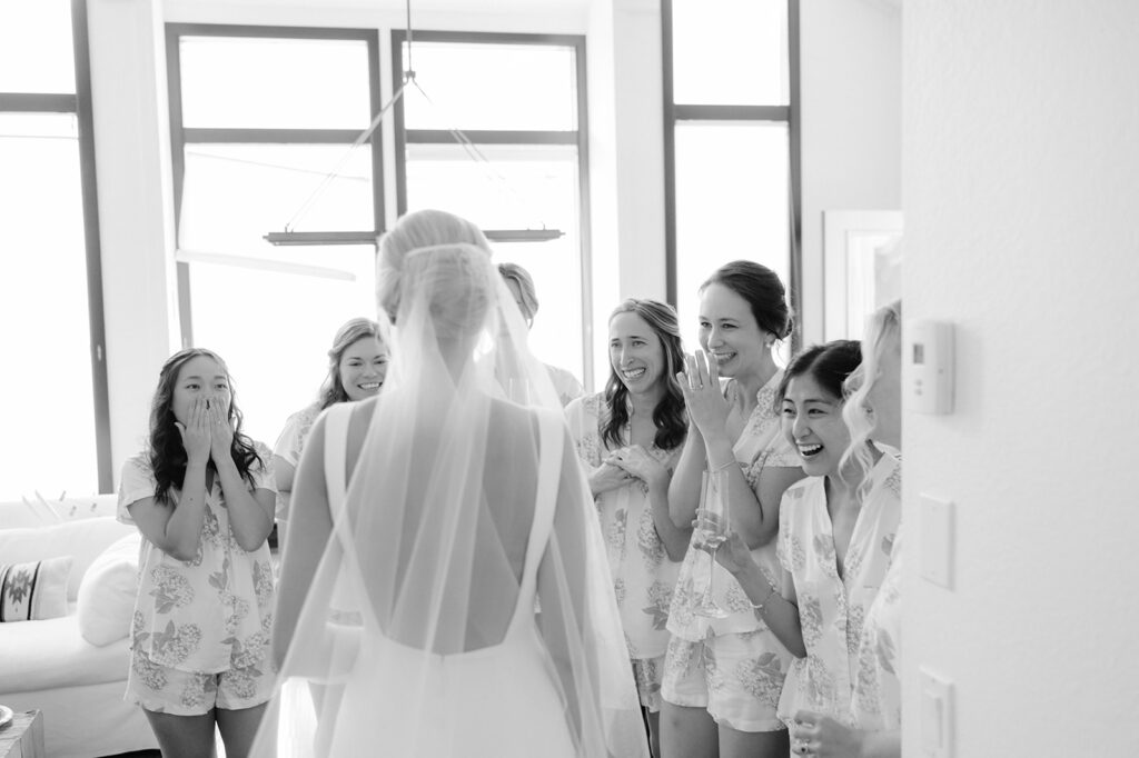 Bridal party seeing the bride in her wedding dress for the first time.