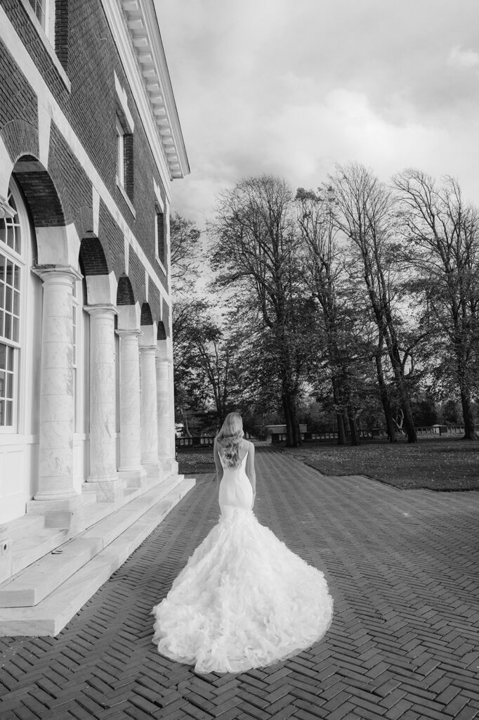 Bride walking outside the Bourne Mansion.