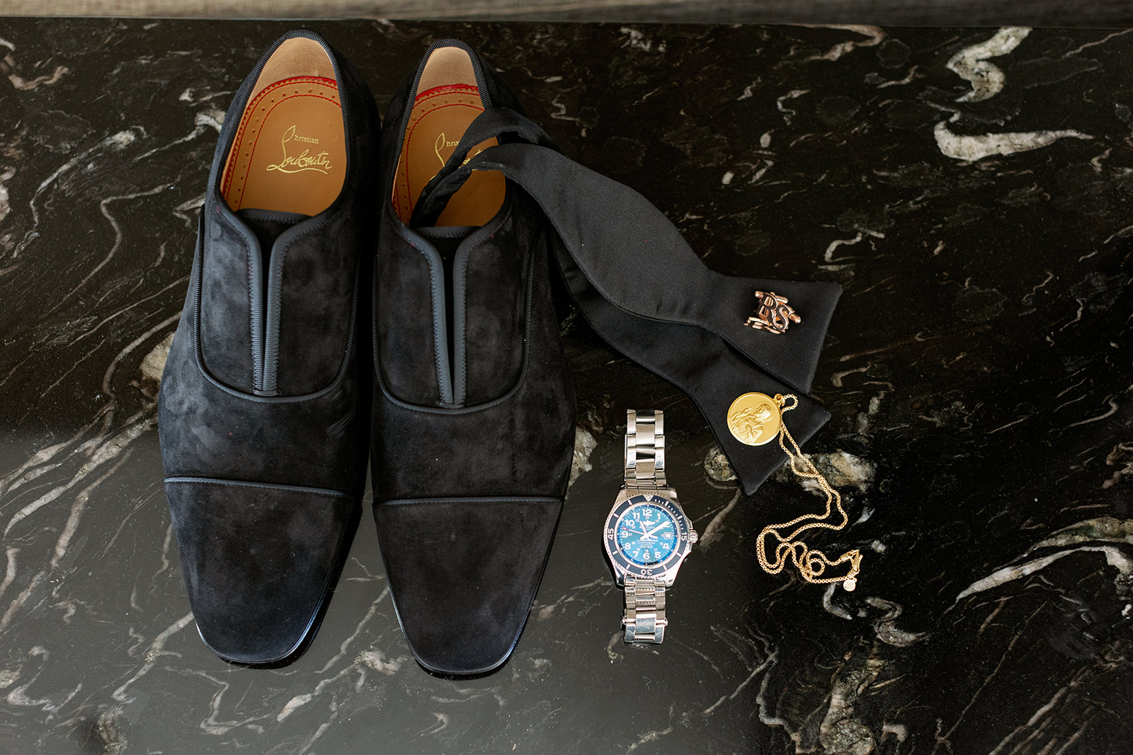 Groom wedding detail flat lay with Christian Louboutin loafers. 