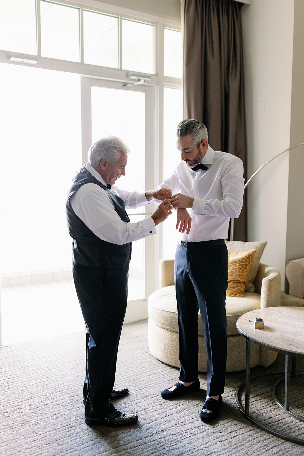 Groom getting ready with his dad.