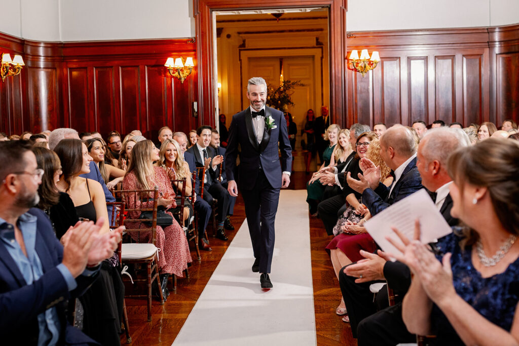Bourne Mansion indoor wedding ceremony groom walking down the aisle.