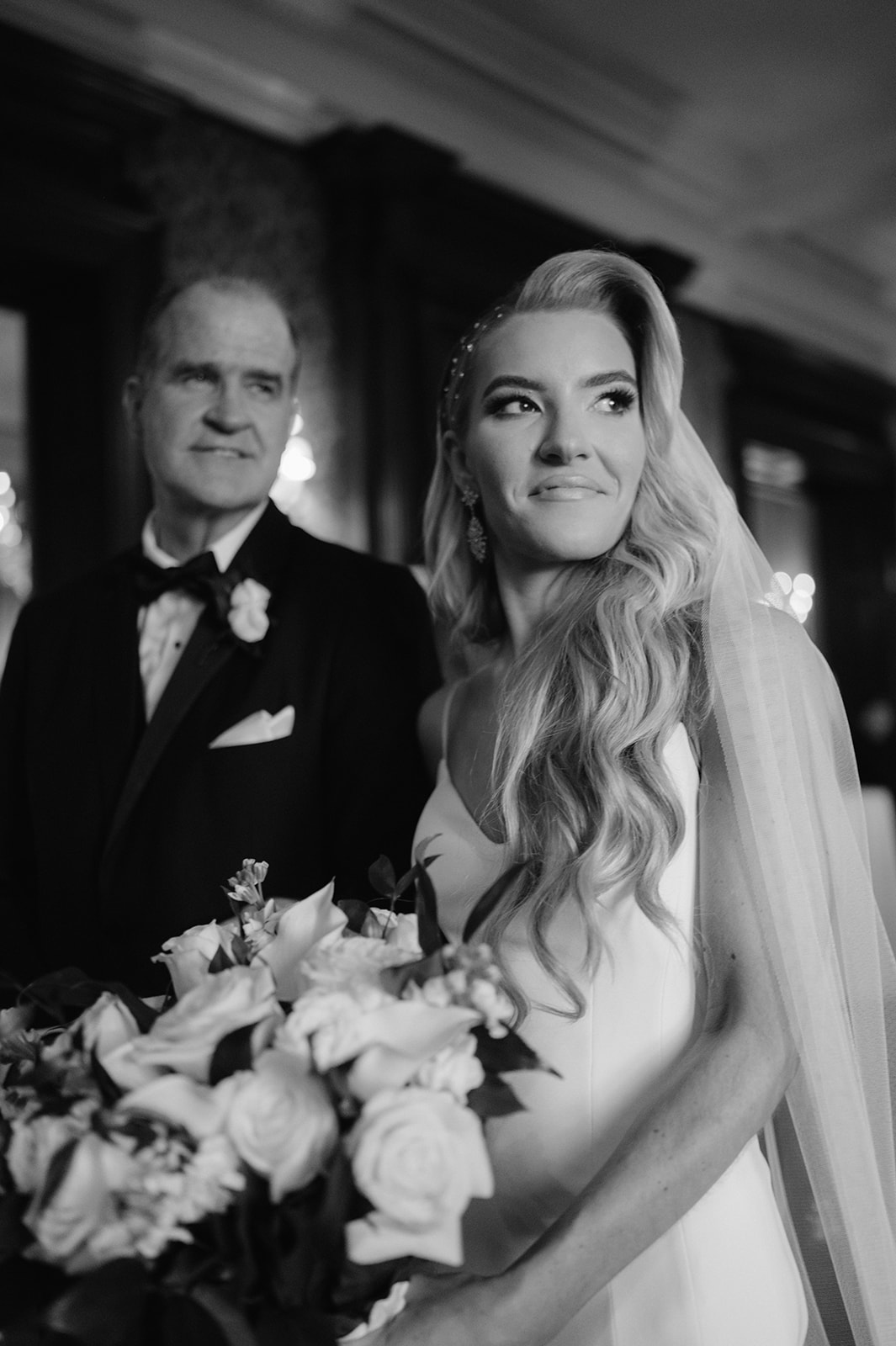 Bride standing with her dad before walking down the aisle.