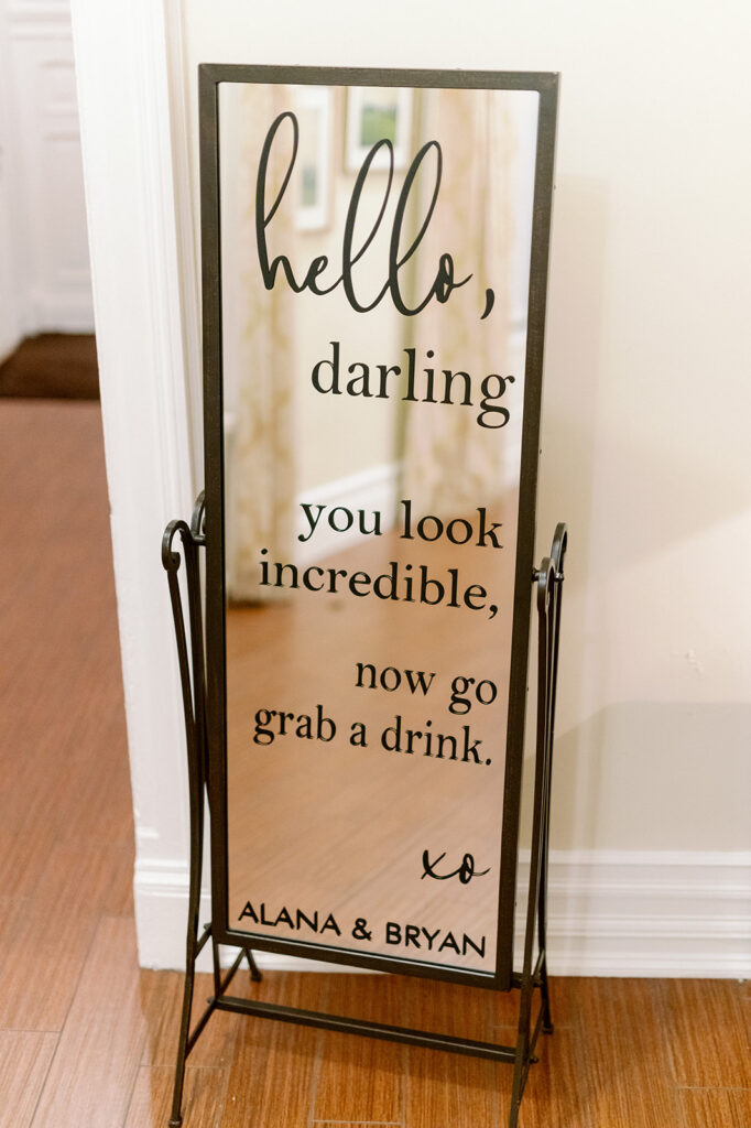 Custom wedding mirror that says "hello, darling you look incredible, now go grab a drink" 