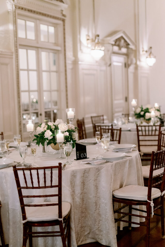White wedding reception at Bourne Mansion with round tables and chiavari chairs.