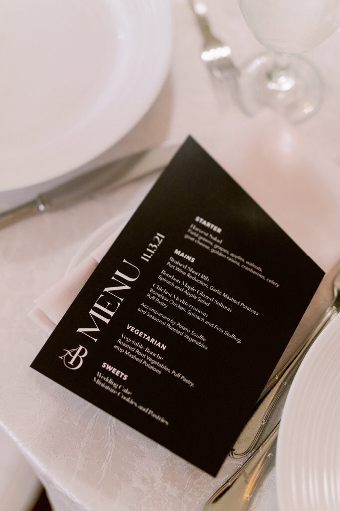 Asymmetrical black wedding reception menu.