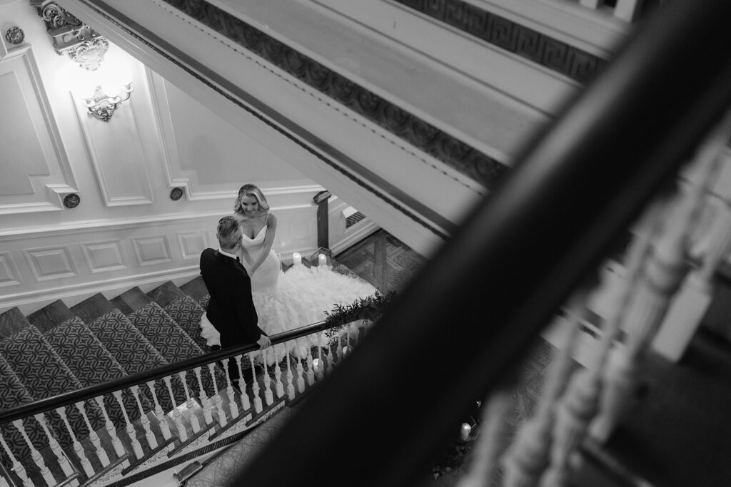 Staircase bride and groom portrait at Bourne Mansion.