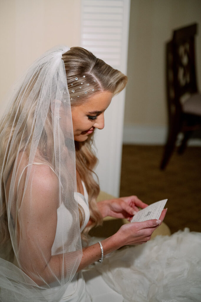 Bride privately reading groom's letter before ceremony.