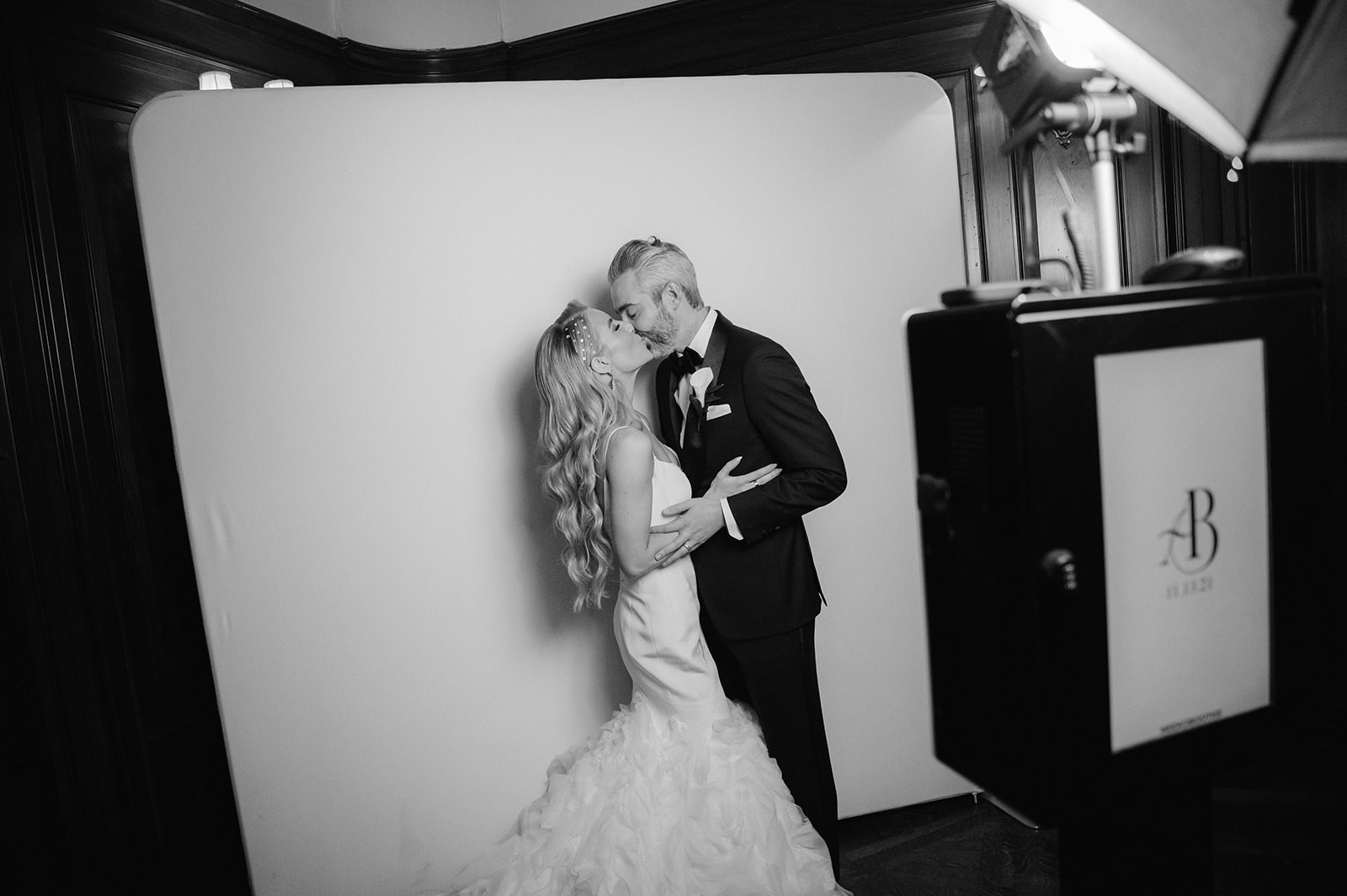 Bride and groom taking a photo booth photo