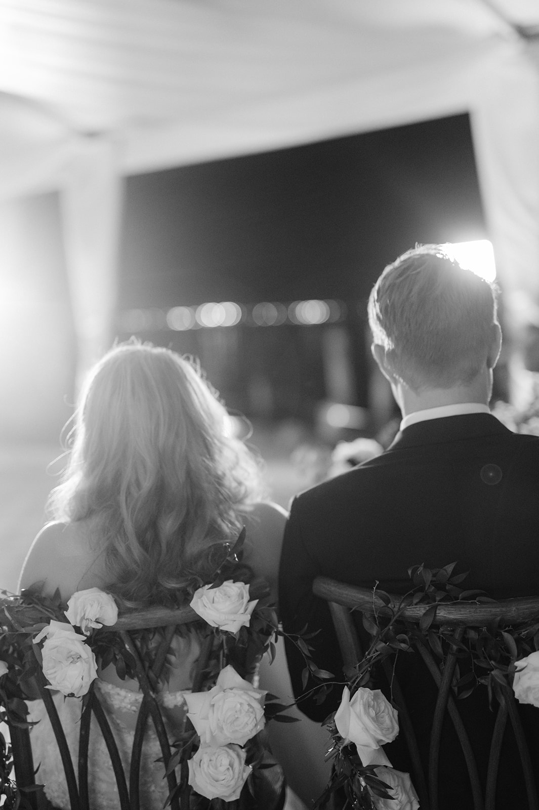 Candid bride and groom portrait listening to dinner speeches.