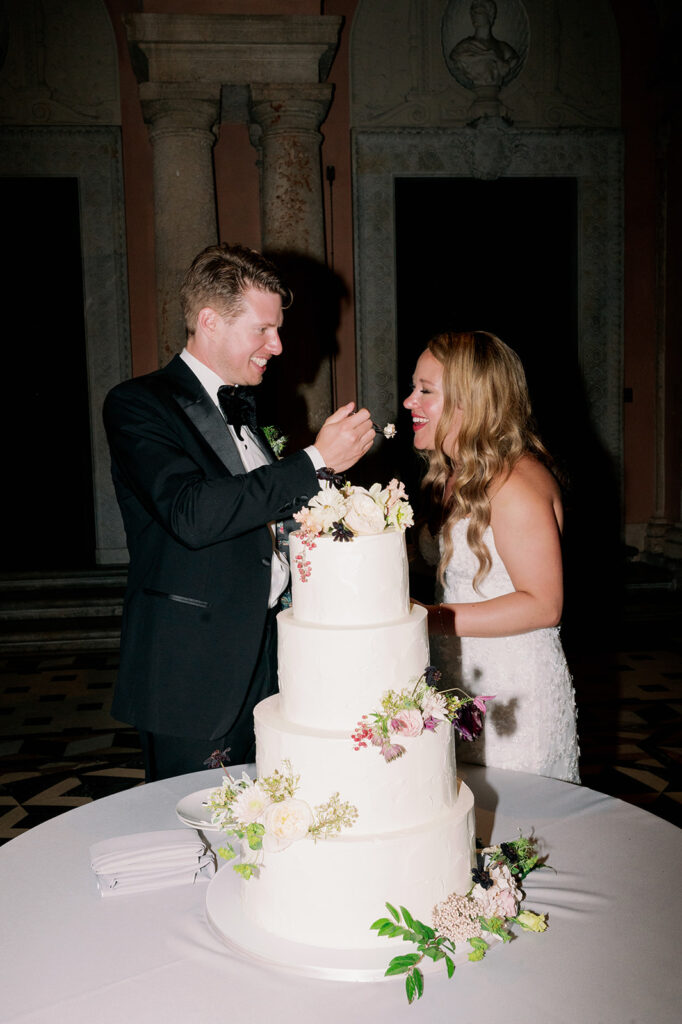 Bride and groom cake cutting flash photo.