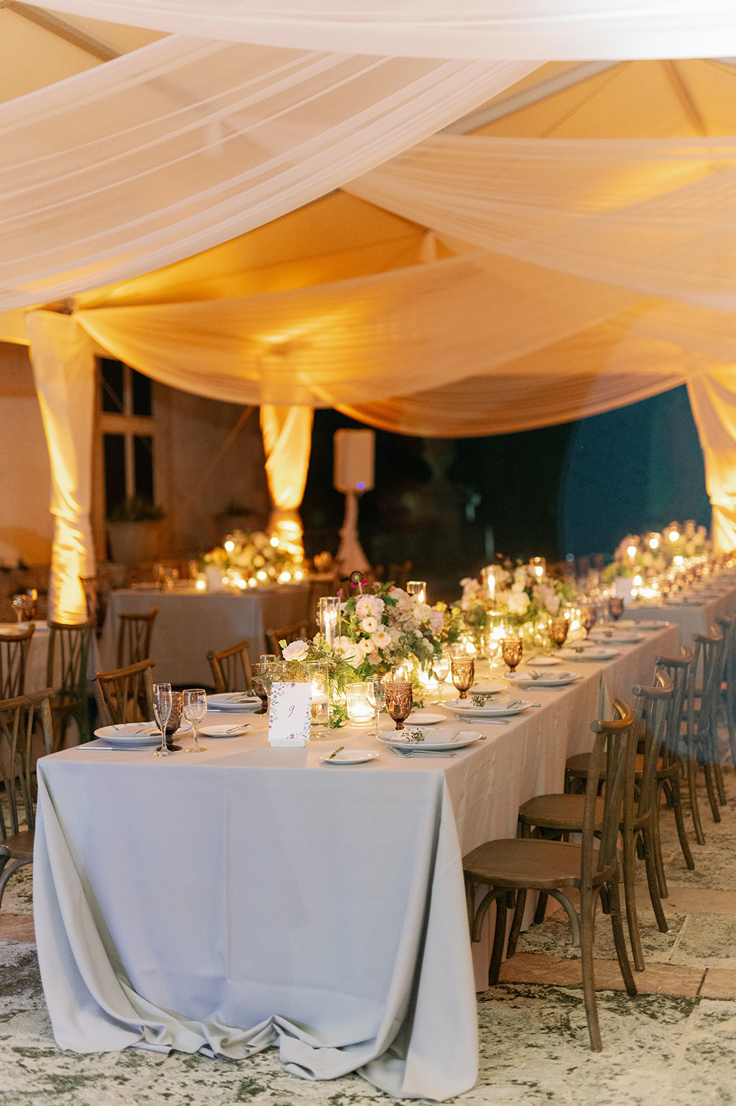 Romantic candlelit tented wedding reception dinner at Vizcaya Museum and Gardens.