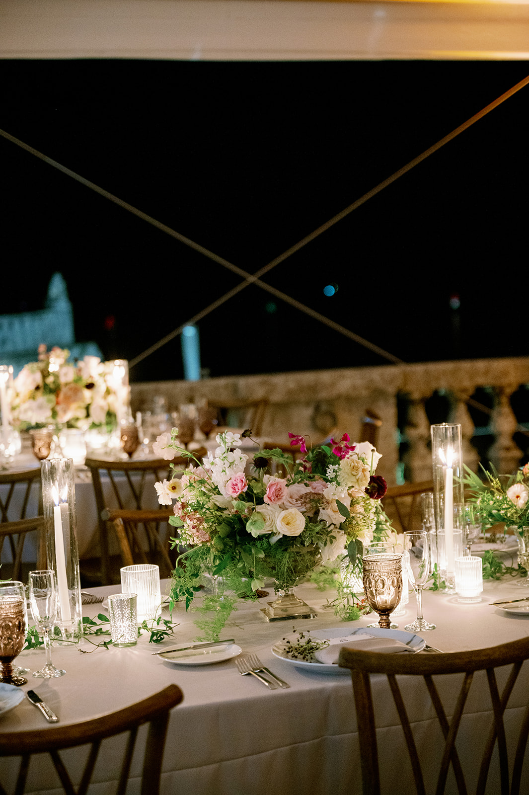 Romantic candlelit tented wedding reception dinner at Vizcaya Museum and Gardens in Miami.