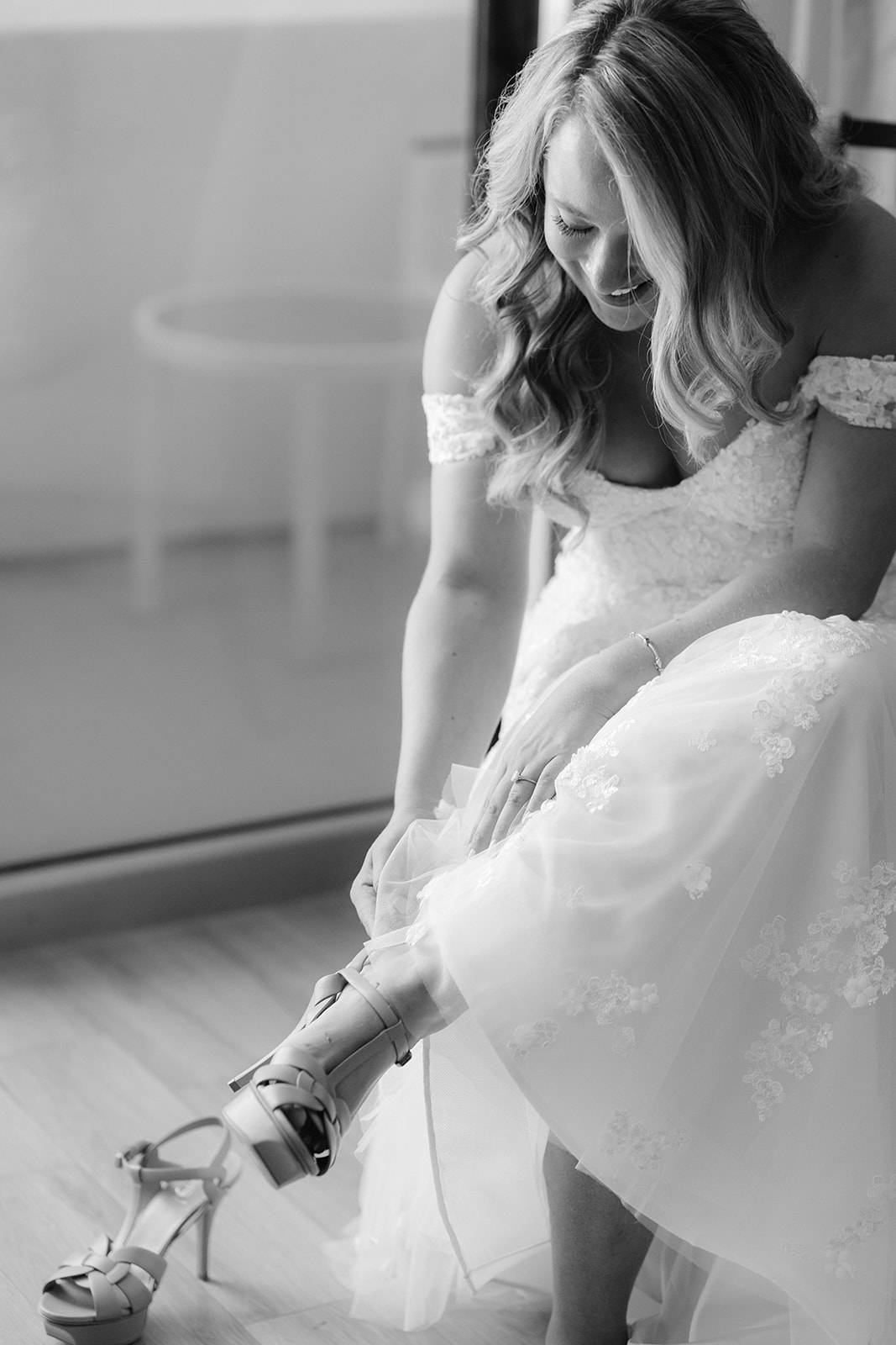 Bride putting on her shoes.