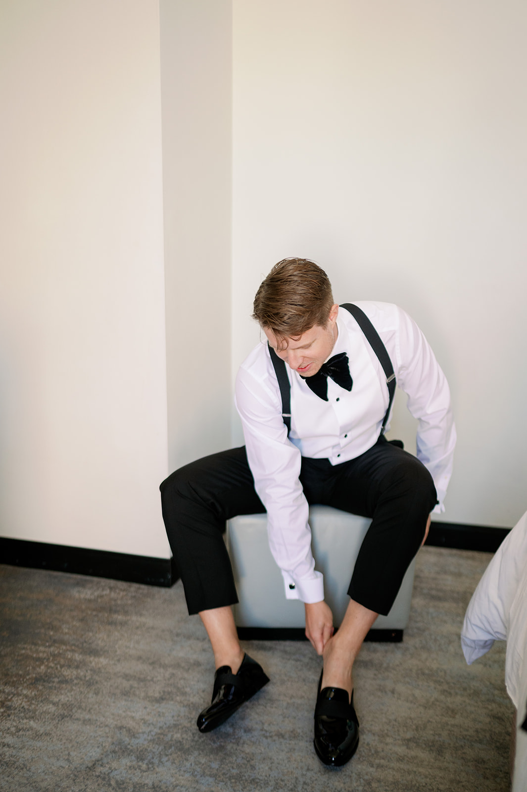 Groom putting on his loafers.
