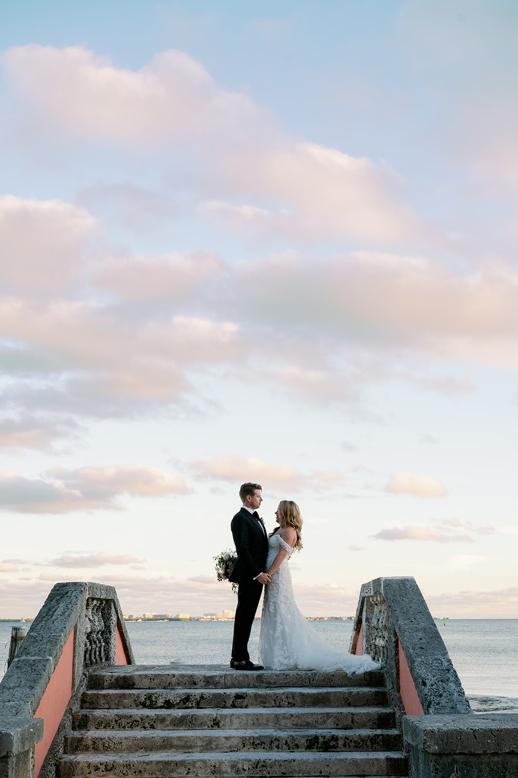 Bride and groom sunset photo on the dock stairs at Vizcaya Museum and Gardens.