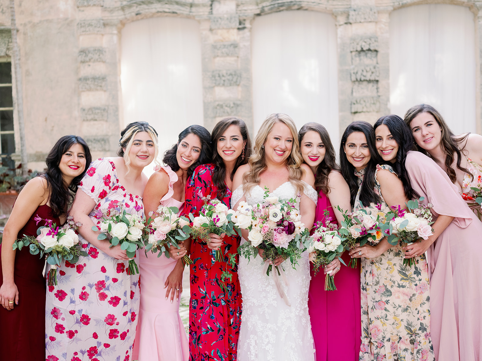 Miami wedding with pink mismatched bridesmaid dresses.
